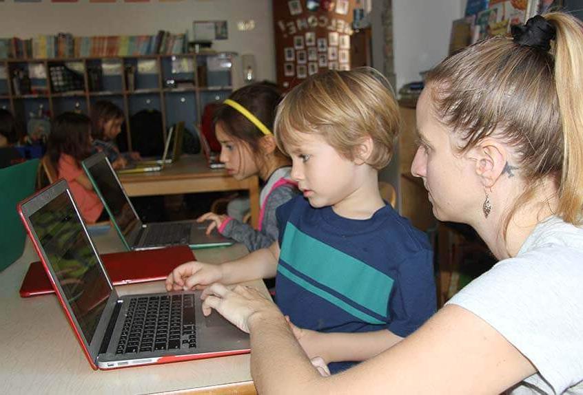 Lower School After School coding - teacher with student